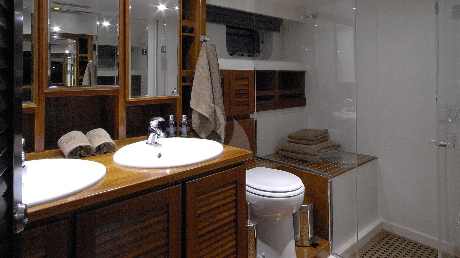 a bathroom with a toilet sink and a mirror aboard XIPHIAS Yacht for Charter