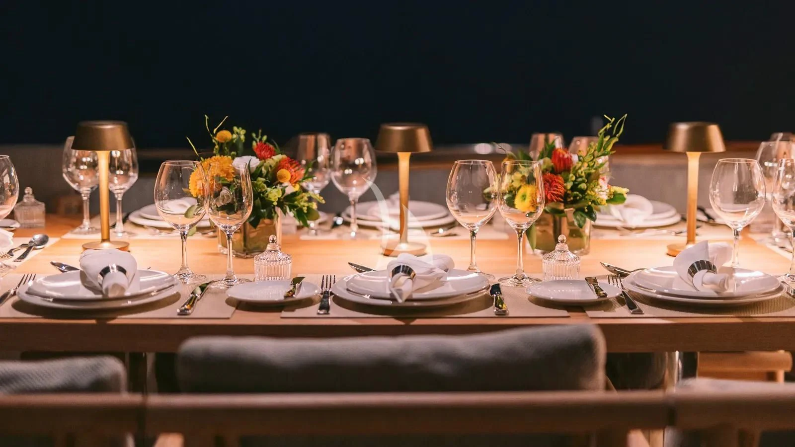 a table set with wine glasses and plates aboard XIPHIAS Yacht for Charter