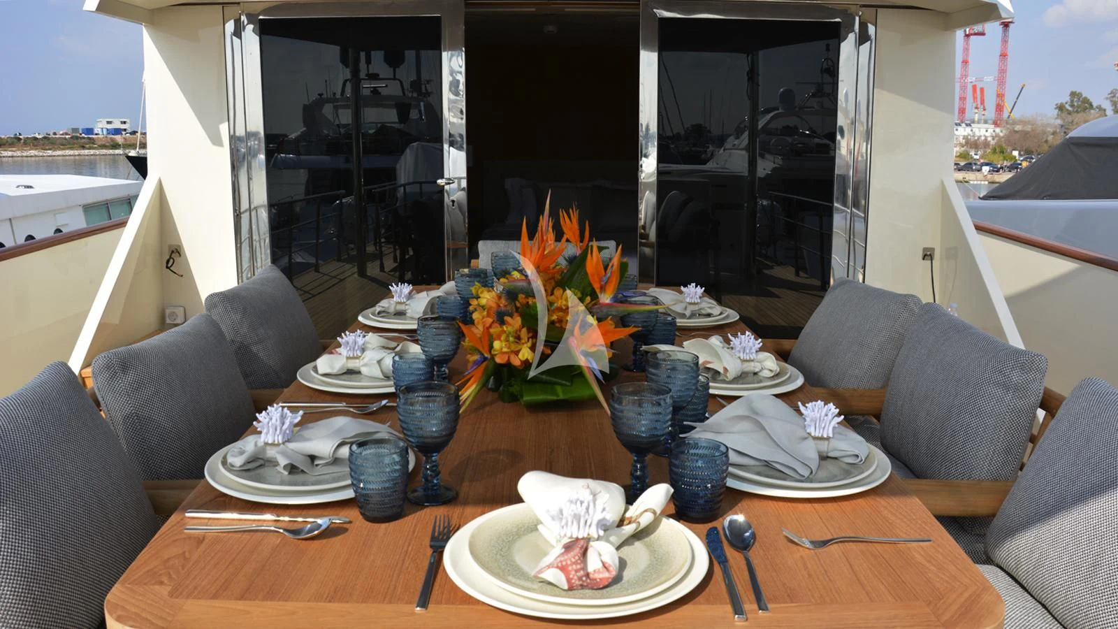 a table with plates and glasses on it aboard XIPHIAS Yacht for Charter