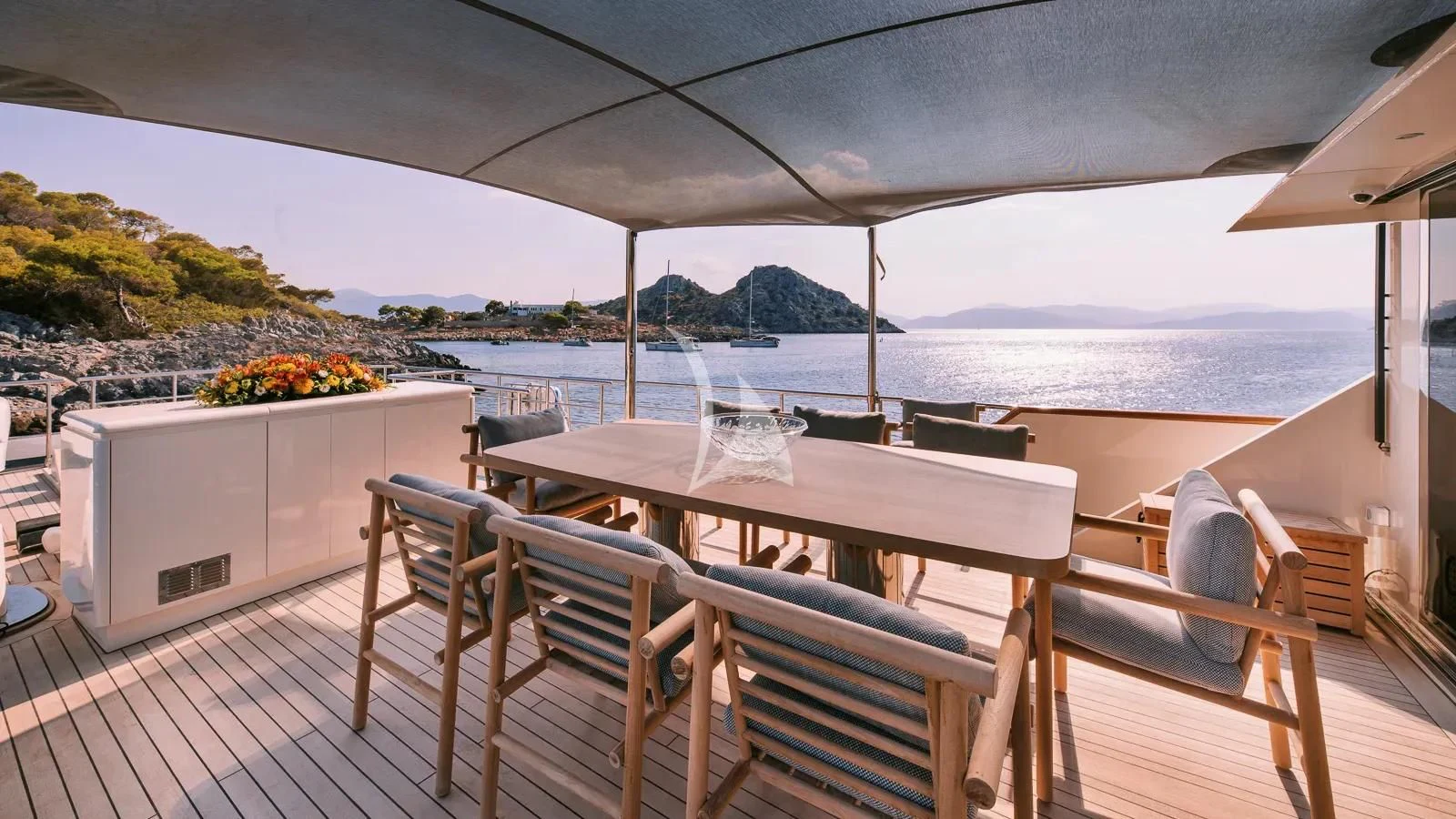 a table and chairs on a deck aboard XIPHIAS Yacht for Charter