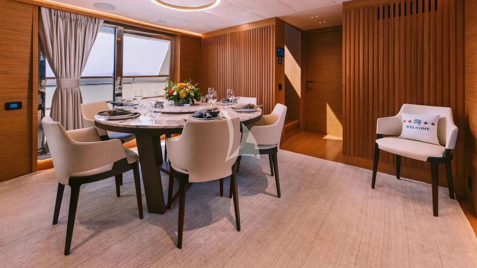 a table with chairs around it aboard XIPHIAS Yacht for Charter