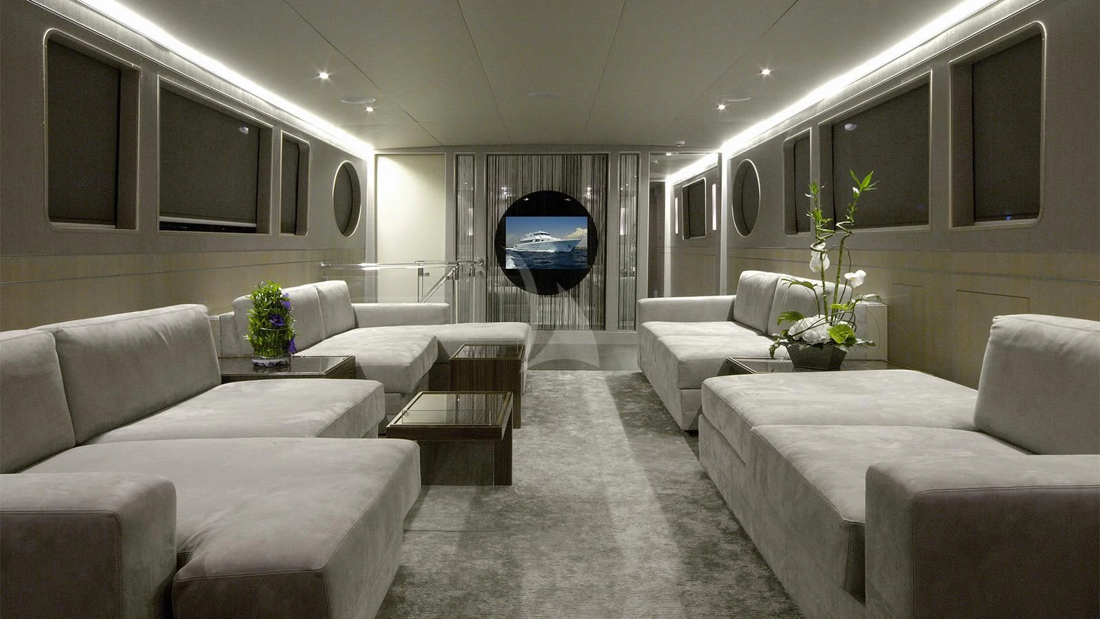 a room with white couches and a television aboard XIPHIAS Yacht for Charter