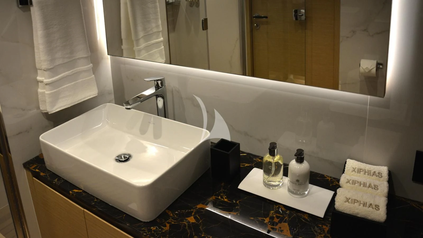 a bathroom with a sink and a mirror aboard XIPHIAS Yacht for Charter