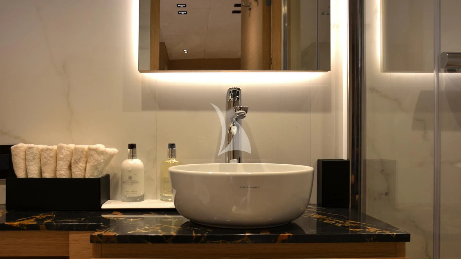 a bathroom sink with a mirror aboard XIPHIAS Yacht for Charter