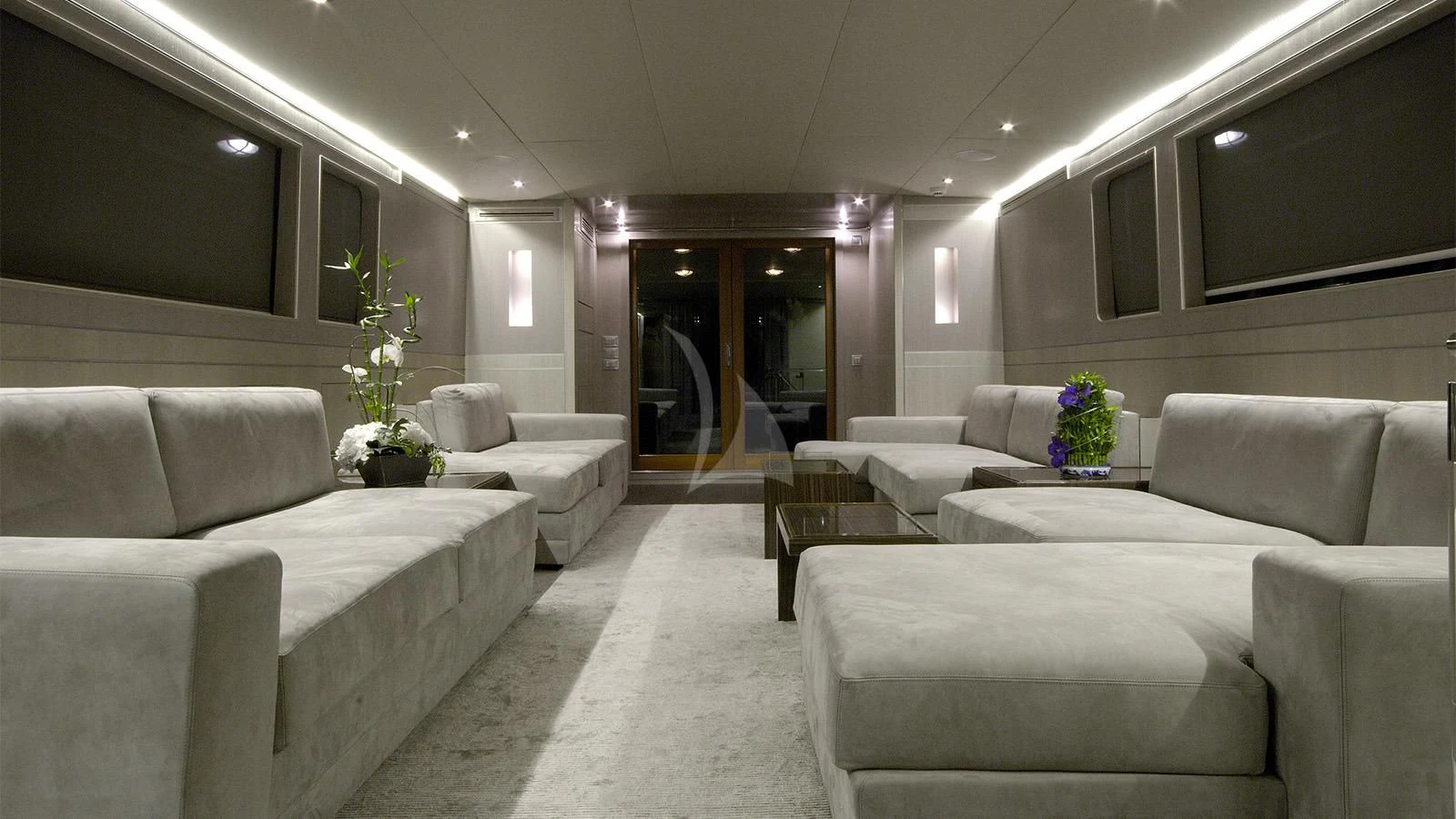 a room with white couches and a large mirror aboard XIPHIAS Yacht for Charter