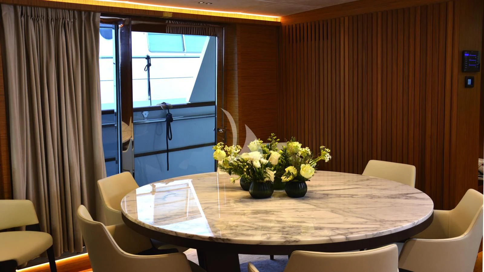 a table with chairs and flowers aboard XIPHIAS Yacht for Charter