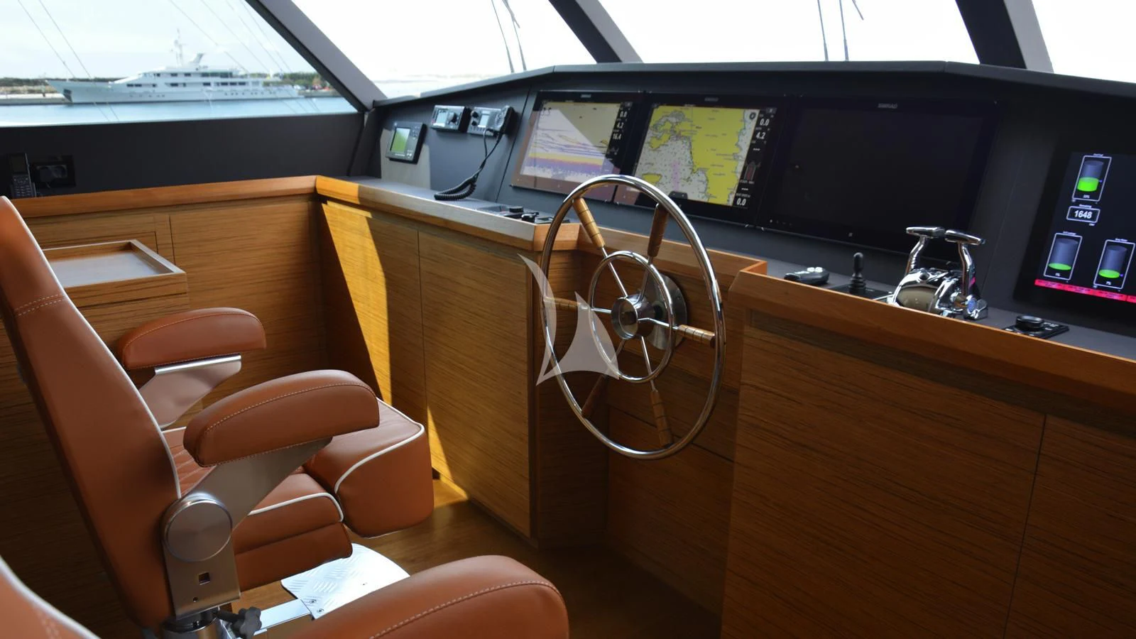 a room with a desk and chairs aboard XIPHIAS Yacht for Charter