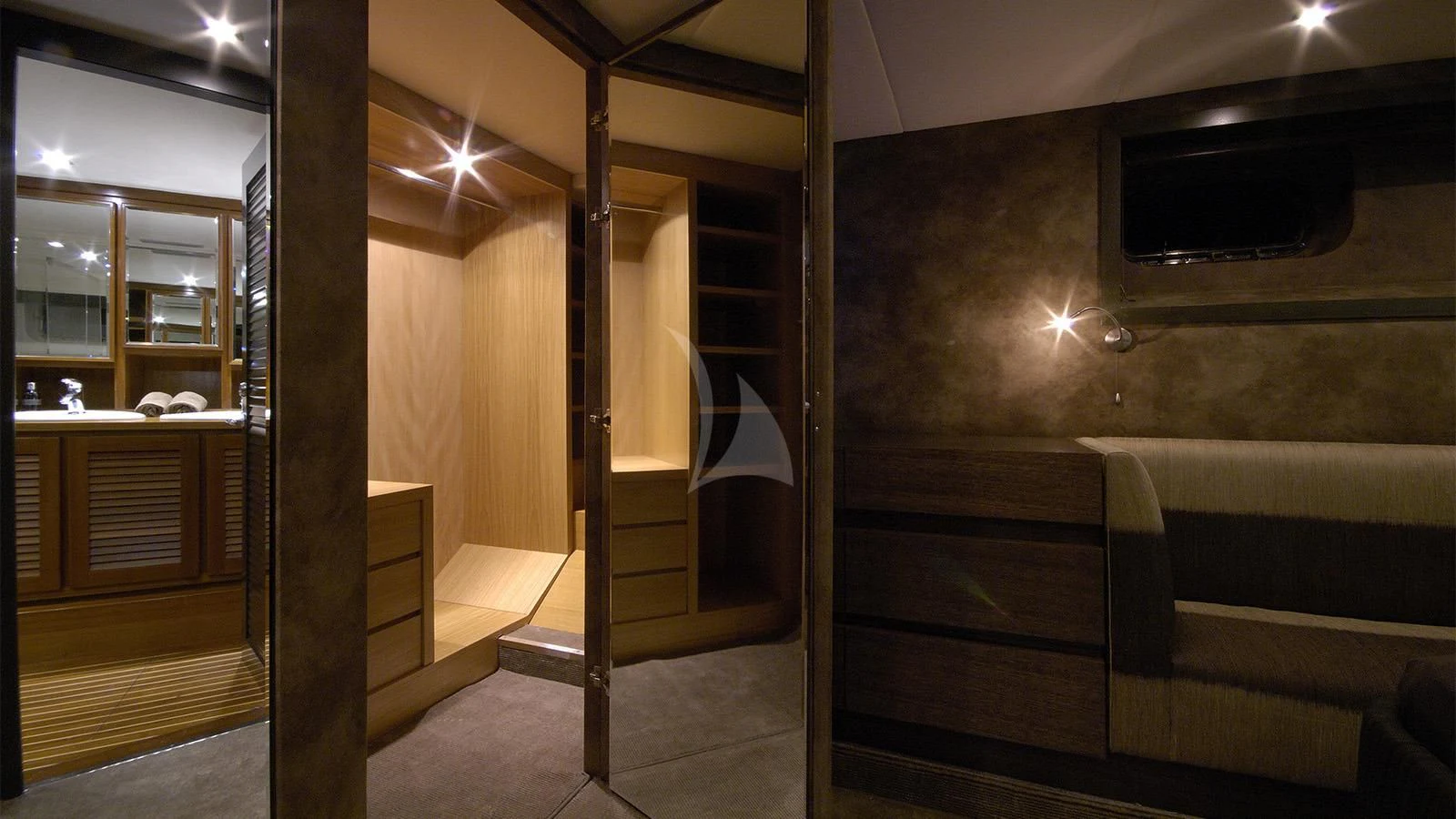 a room with a wood door and a tv on the wall aboard XIPHIAS Yacht for Charter