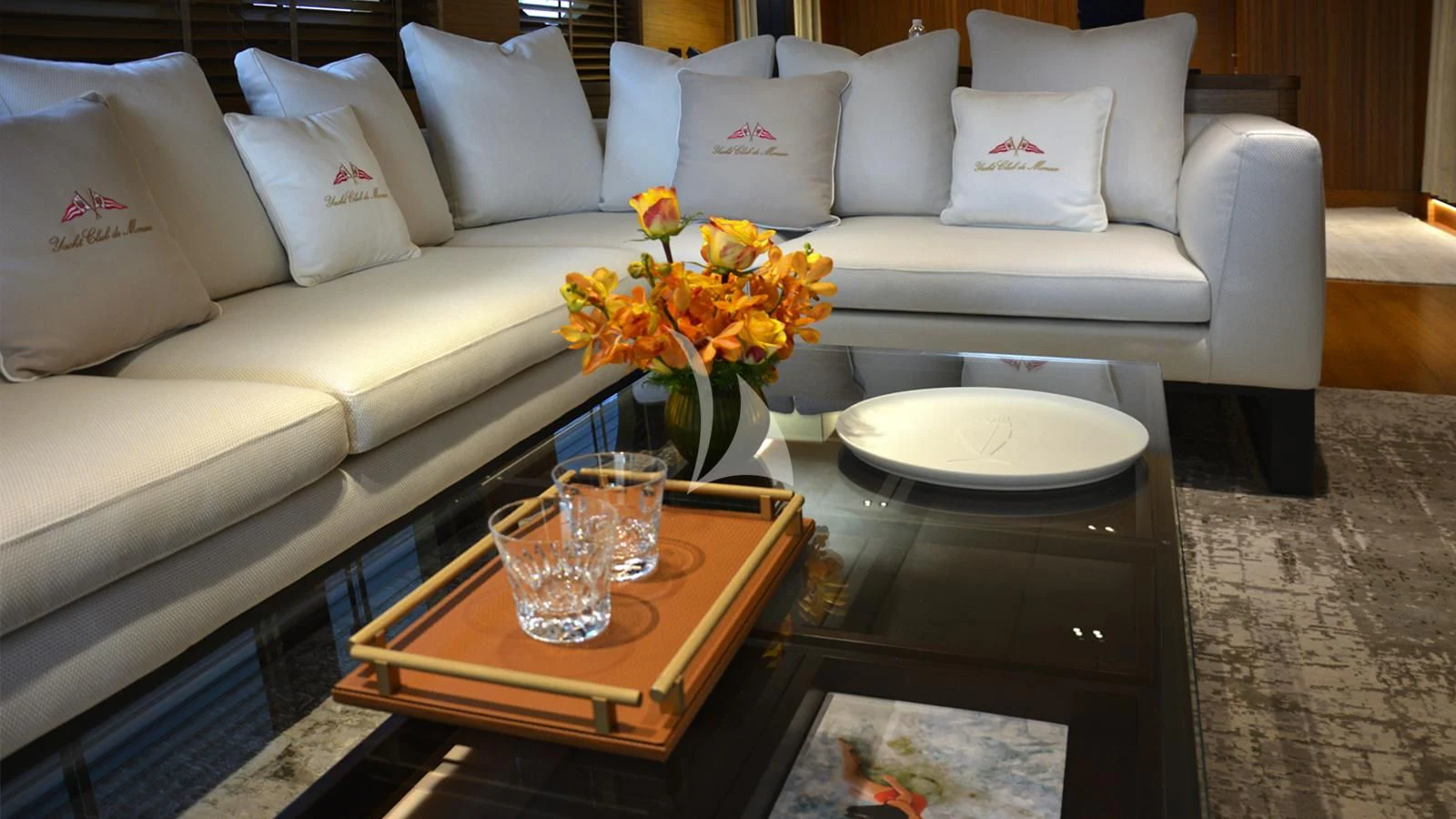 a living room with a white couch and a coffee table aboard XIPHIAS Yacht for Charter