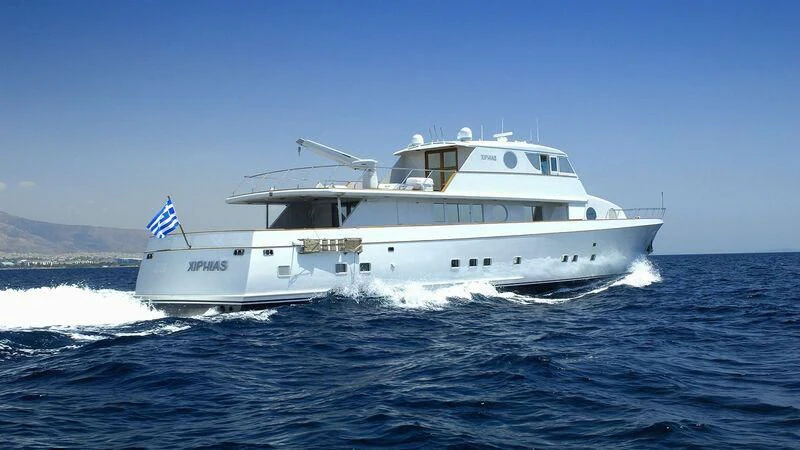 a large white boat on the water aboard XIPHIAS Yacht for Charter