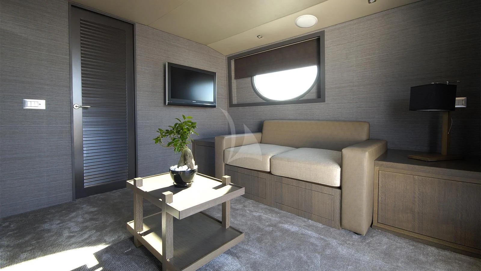 a living room with a couch and a coffee table aboard XIPHIAS Yacht for Charter
