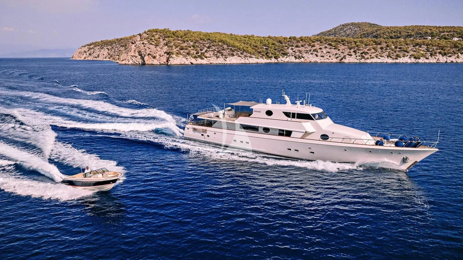 a white yacht on the water aboard XIPHIAS Yacht for Charter