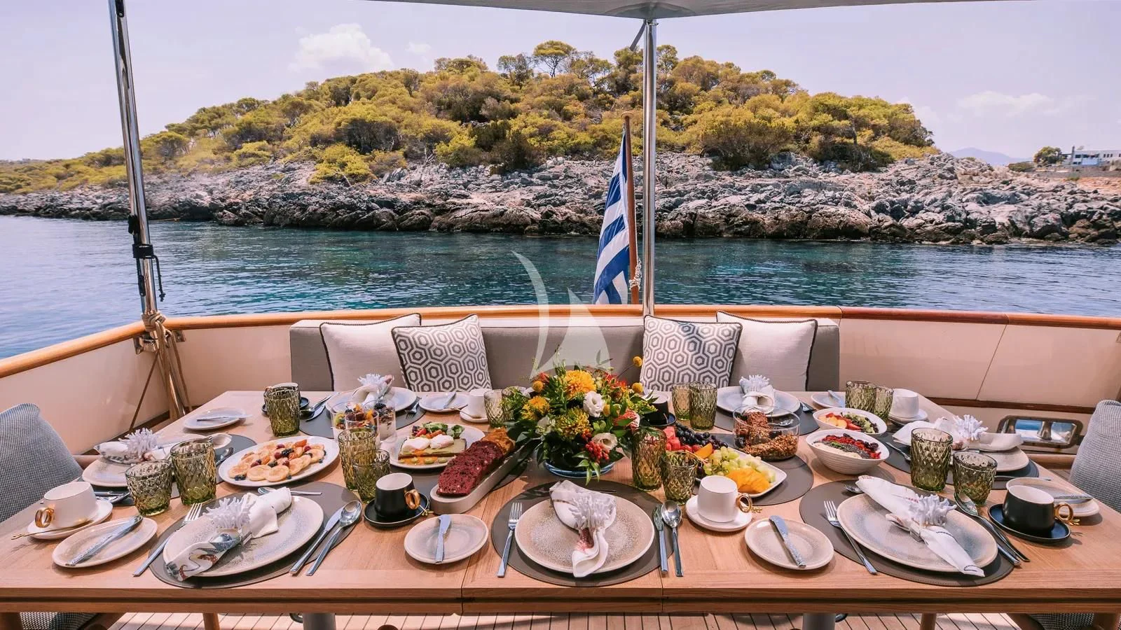 a table set for a dinner on a boat aboard XIPHIAS Yacht for Charter