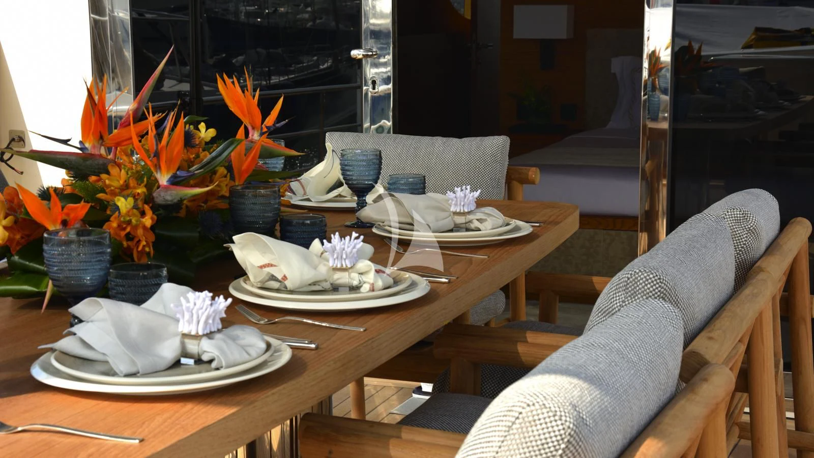 a table with plates and glasses aboard XIPHIAS Yacht for Charter
