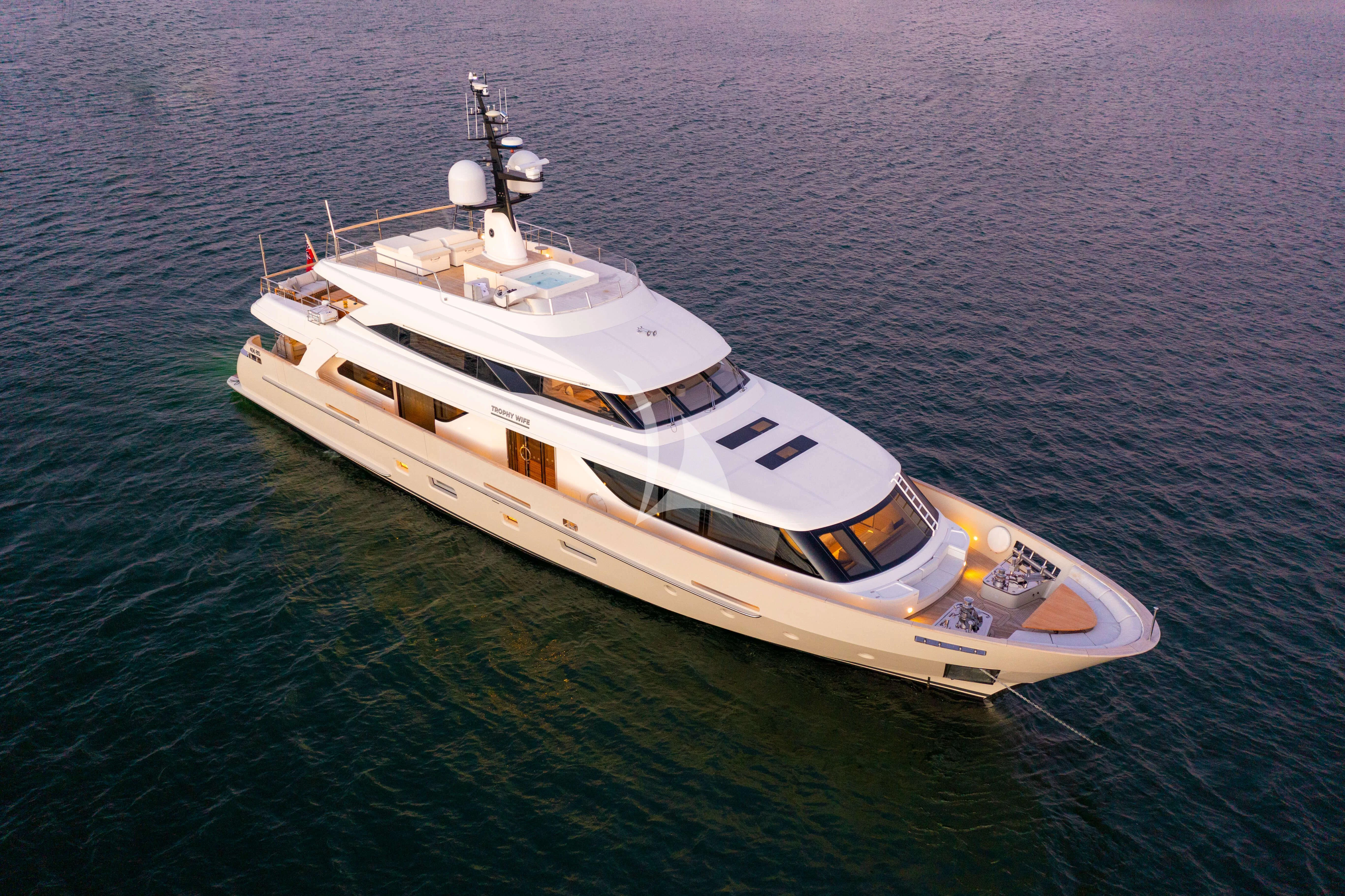 a white and yellow boat on the water aboard TINY WAVE Yacht for Sale