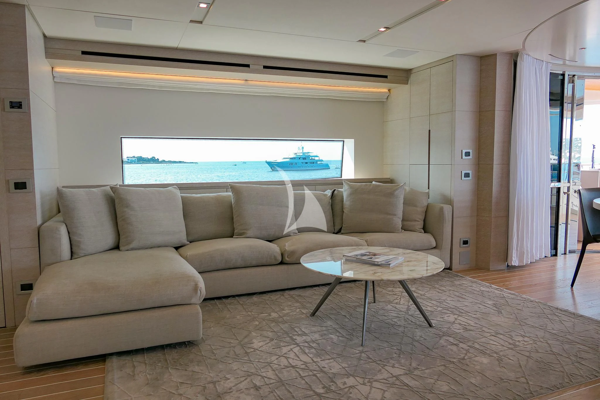 a living room with a couch and a table aboard TINY WAVE Yacht for Sale