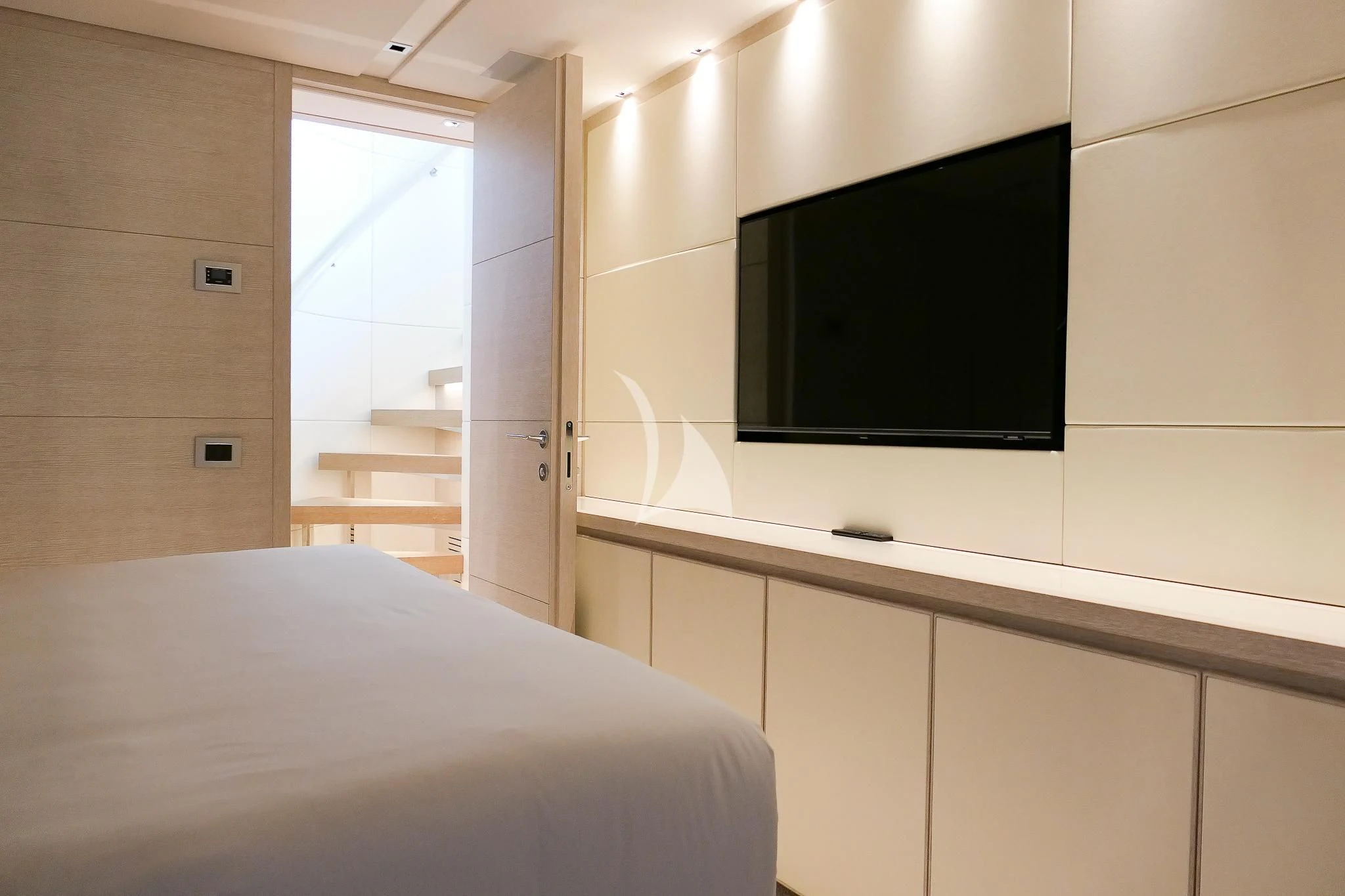 a room with a bed and a tv on the wall aboard TINY WAVE Yacht for Sale
