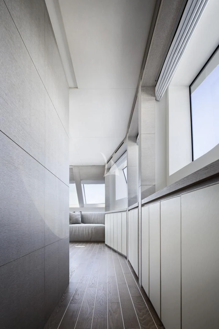 a long hallway with windows aboard TINY WAVE Yacht for Sale