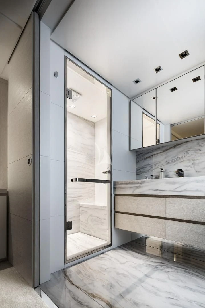 a bathroom with a glass shower aboard TINY WAVE Yacht for Sale