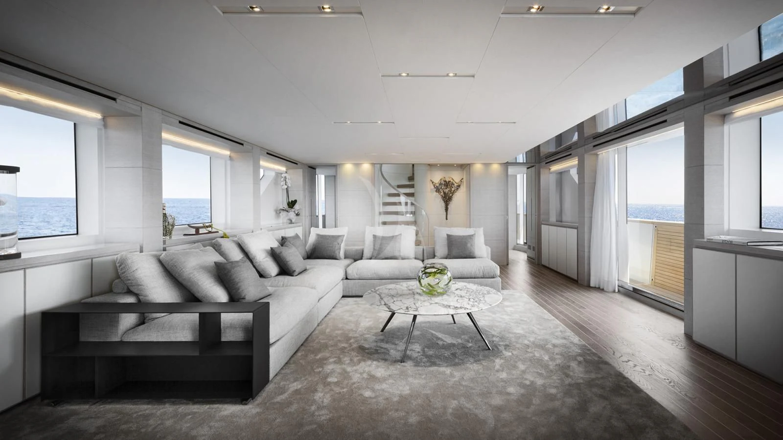 a living room with a large white sofa and a large window aboard TINY WAVE Yacht for Sale