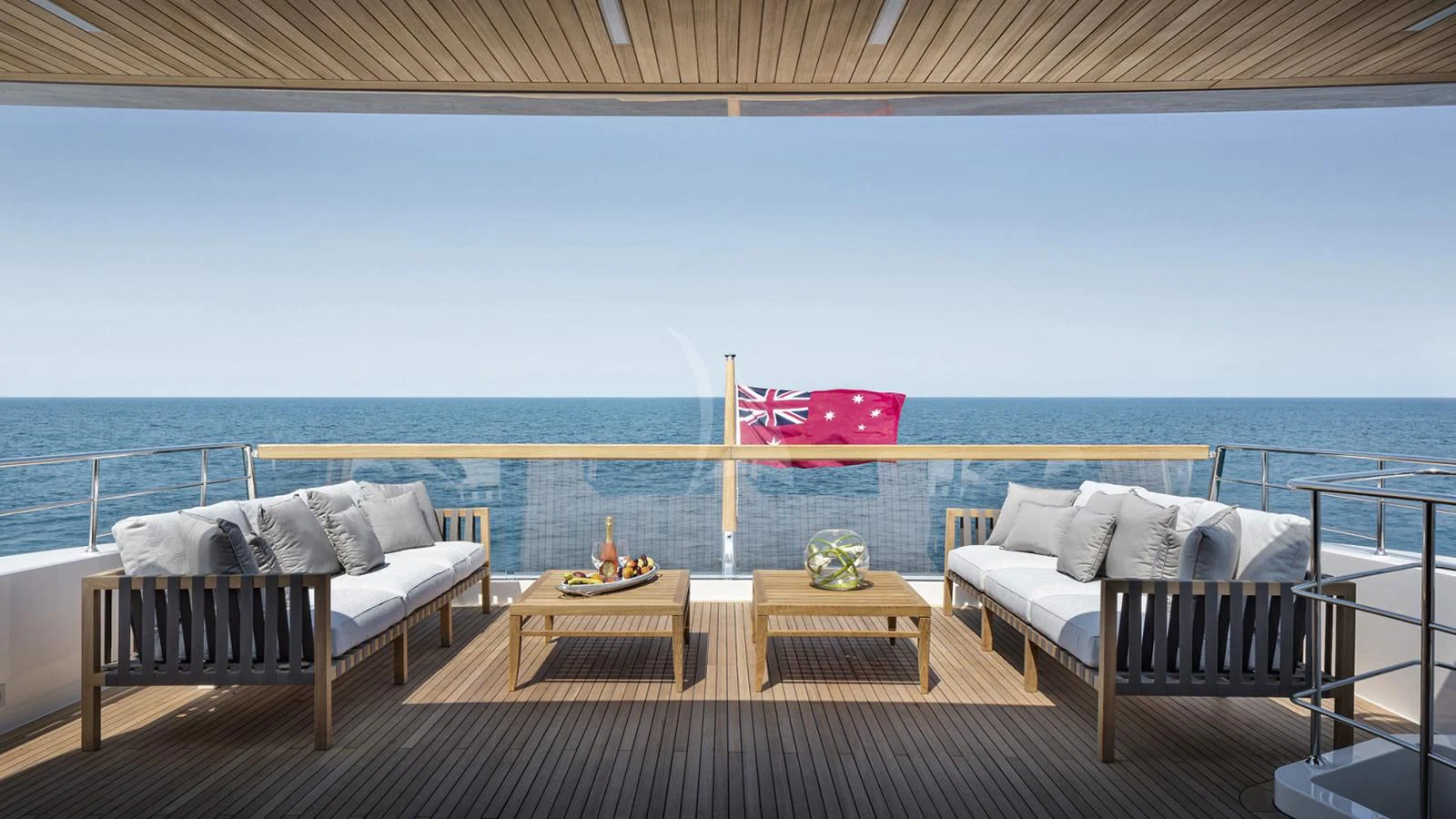 a deck with a view of the ocean and the ocean aboard TINY WAVE Yacht for Sale