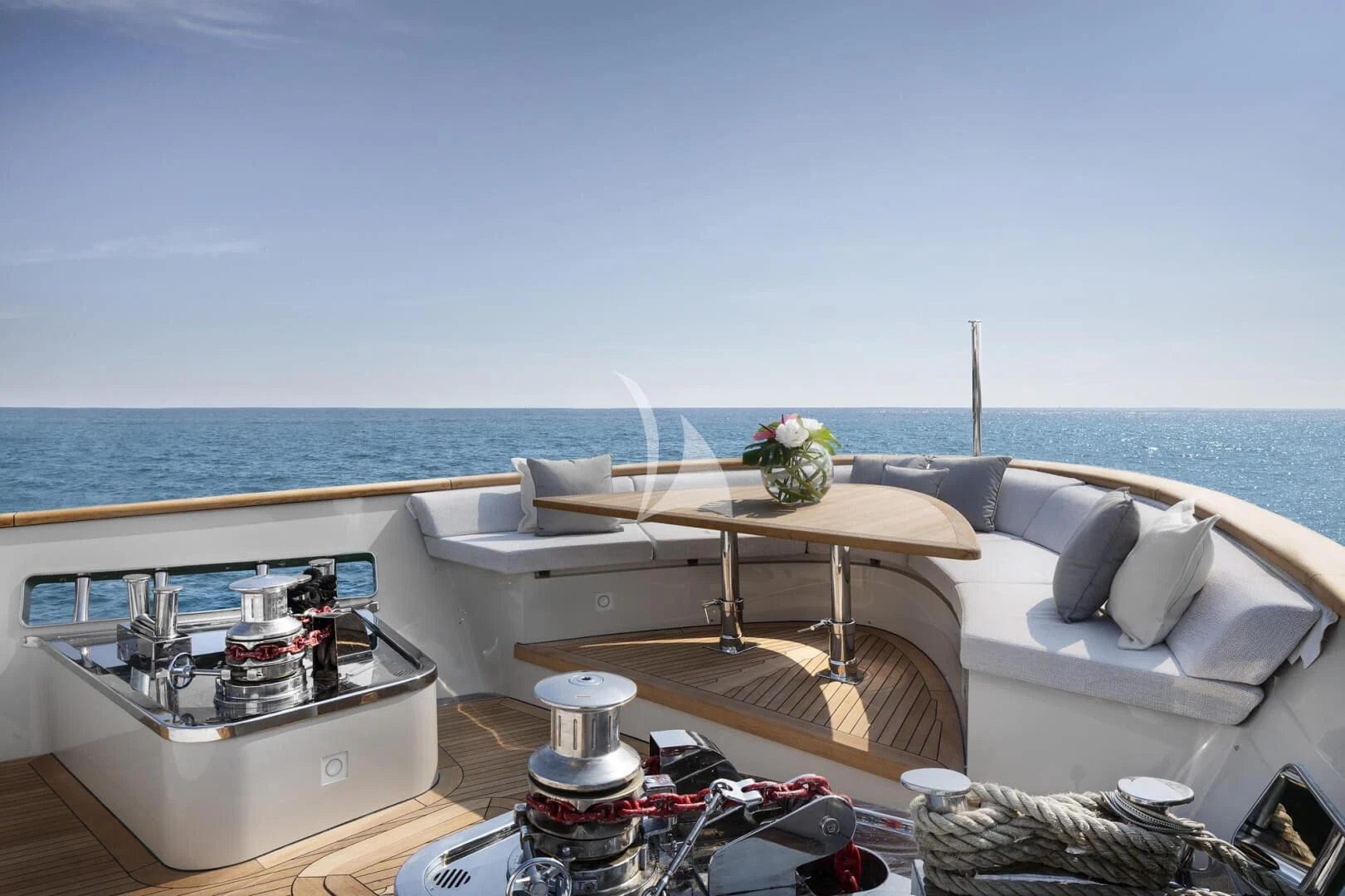 a room with a bed and a table with a chair and a large body of water in the aboard TINY WAVE Yacht for Sale