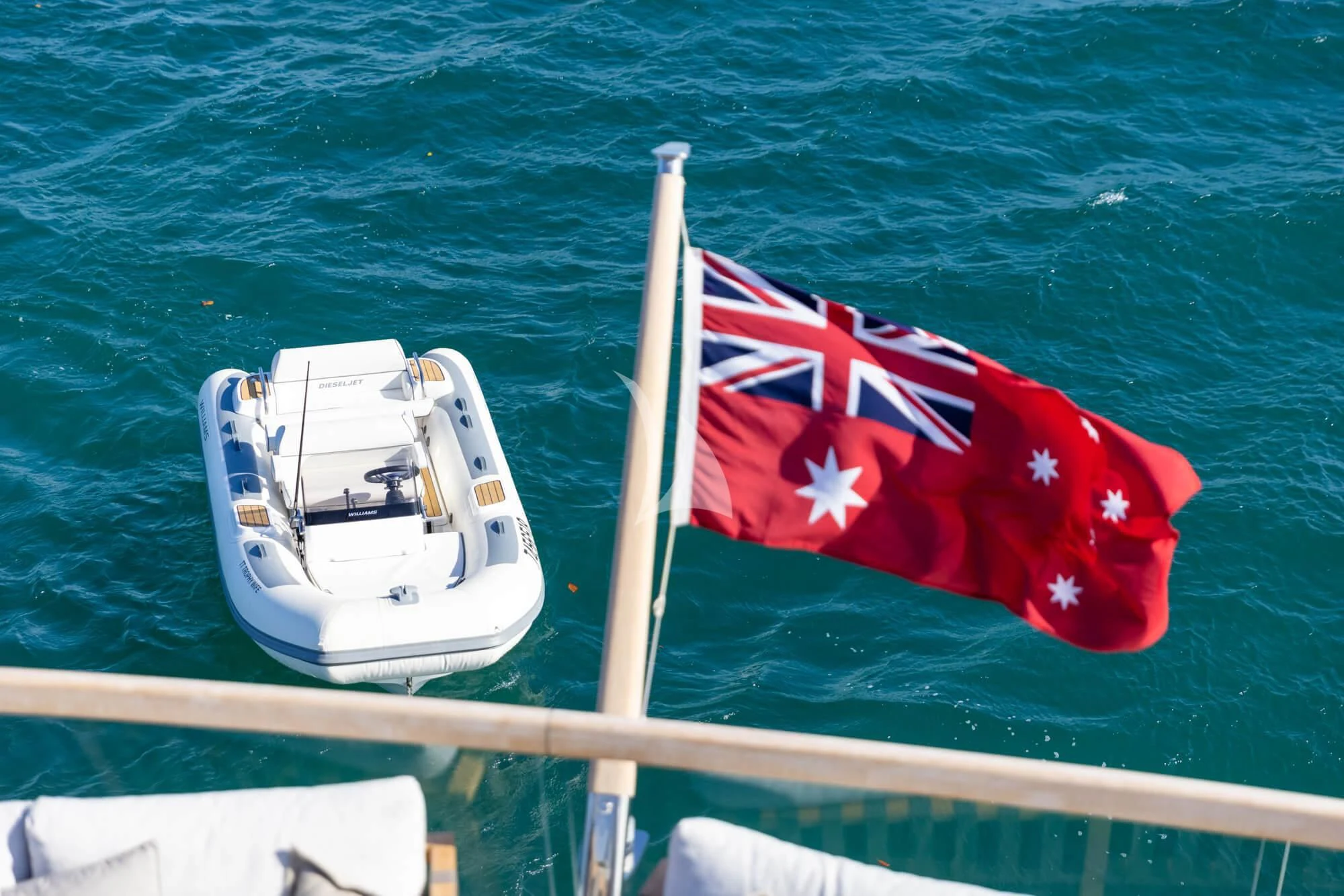 a boat with a flag on it aboard TINY WAVE Yacht for Sale