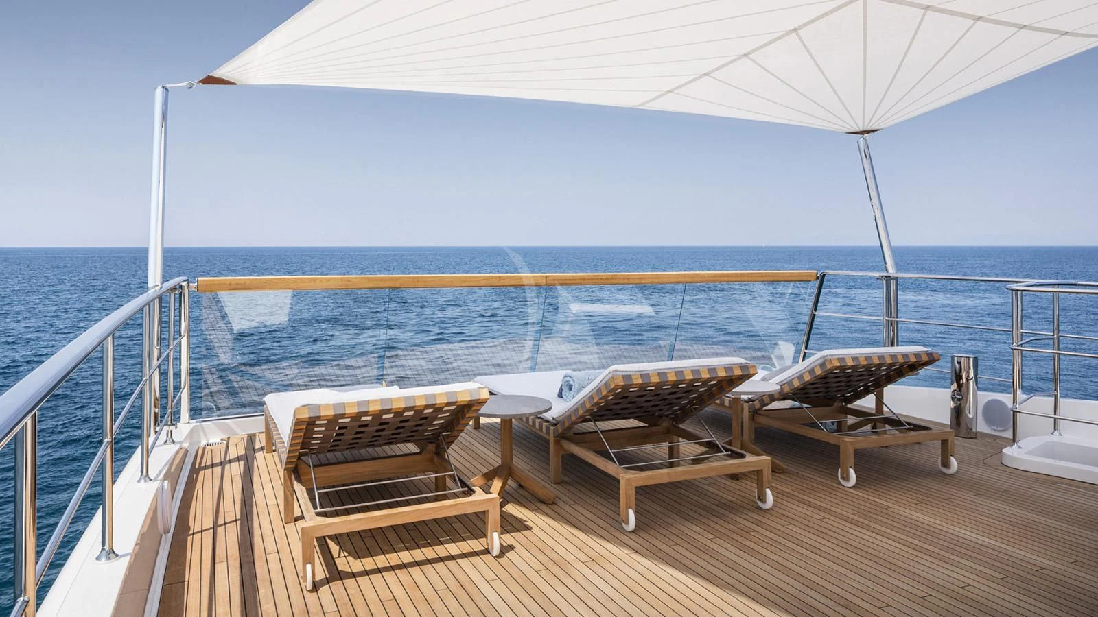 a couple of beds on a deck overlooking the ocean aboard TINY WAVE Yacht for Sale