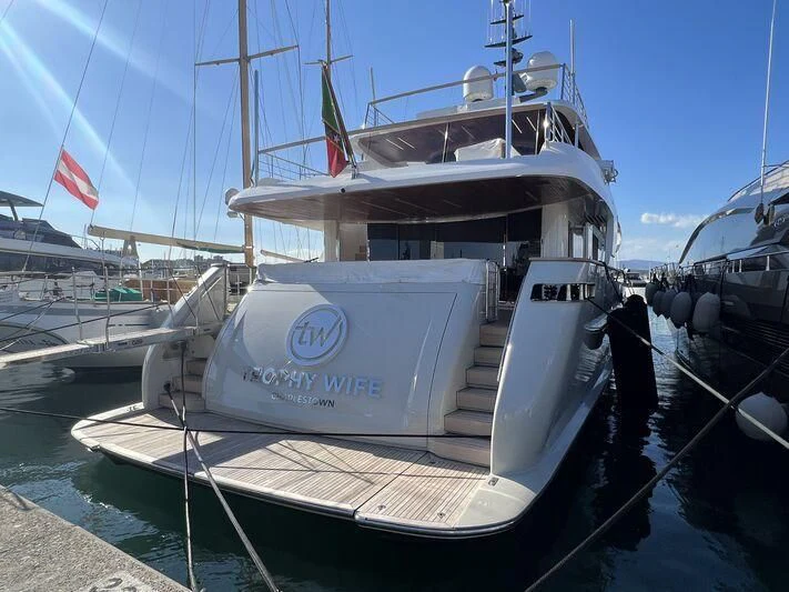 a large white boat in a harbor aboard TINY WAVE Yacht for Sale