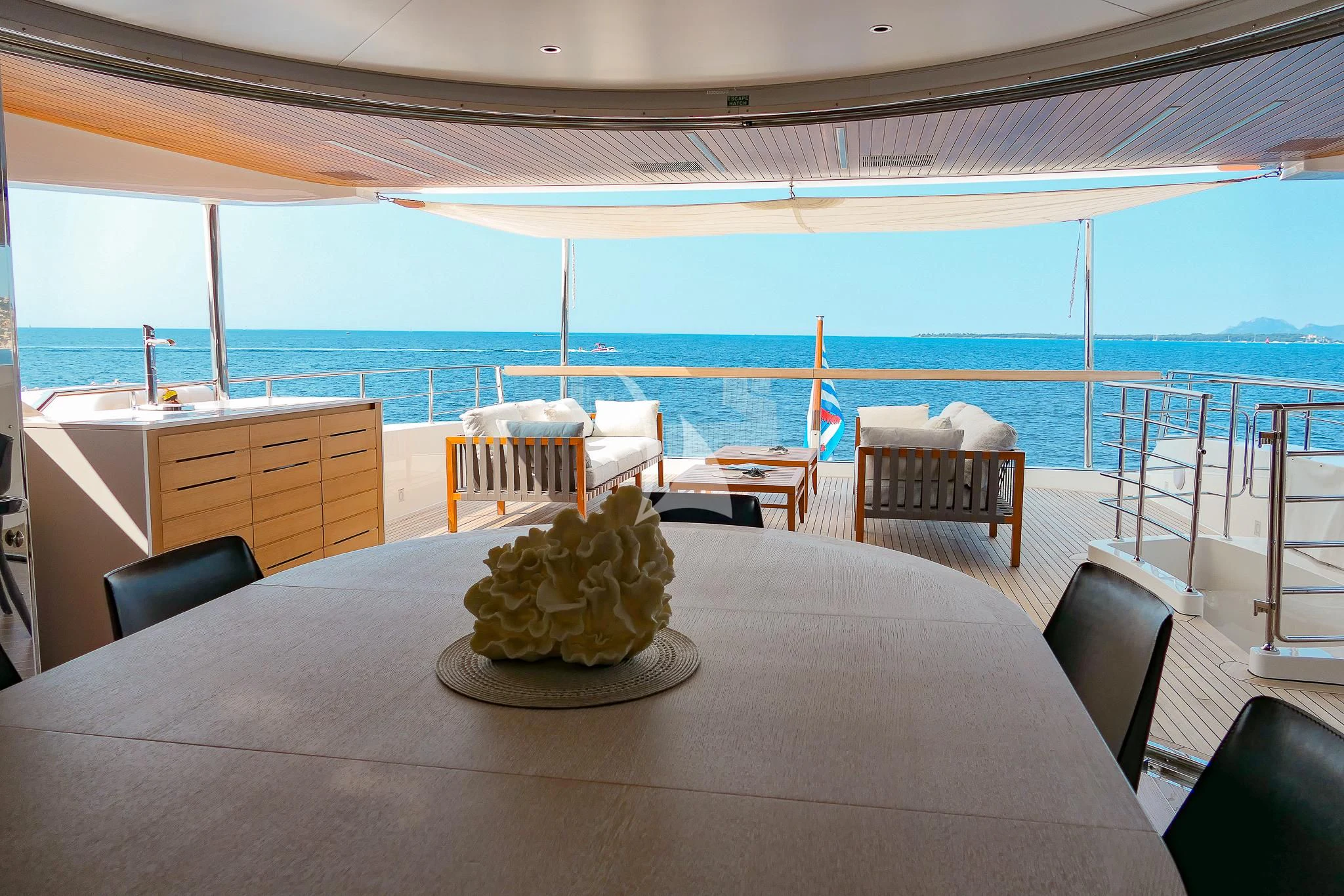 a large room with a table and chairs and a view of the ocean aboard TINY WAVE Yacht for Sale