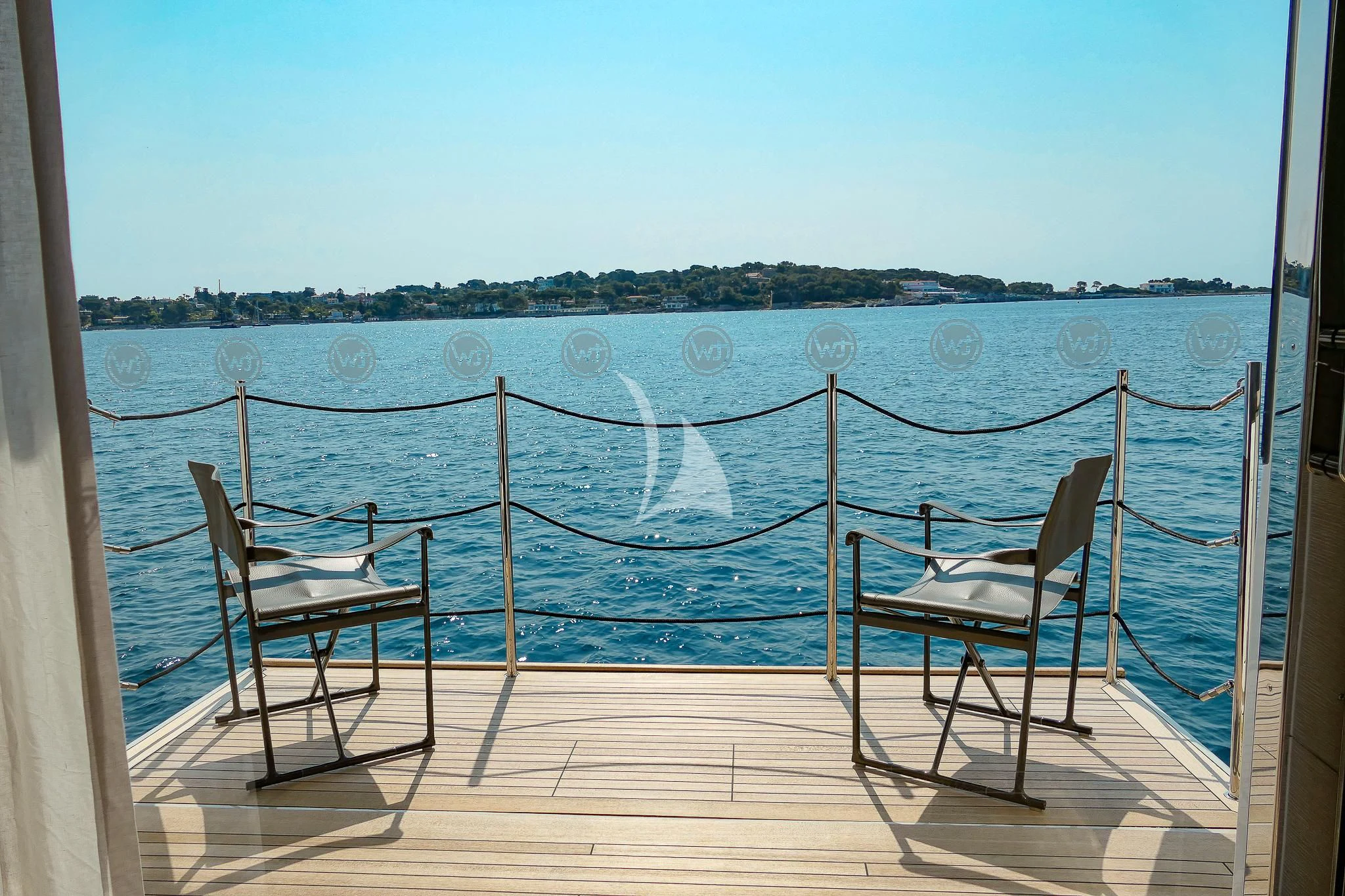 chairs on a deck overlooking a body of water aboard TINY WAVE Yacht for Sale