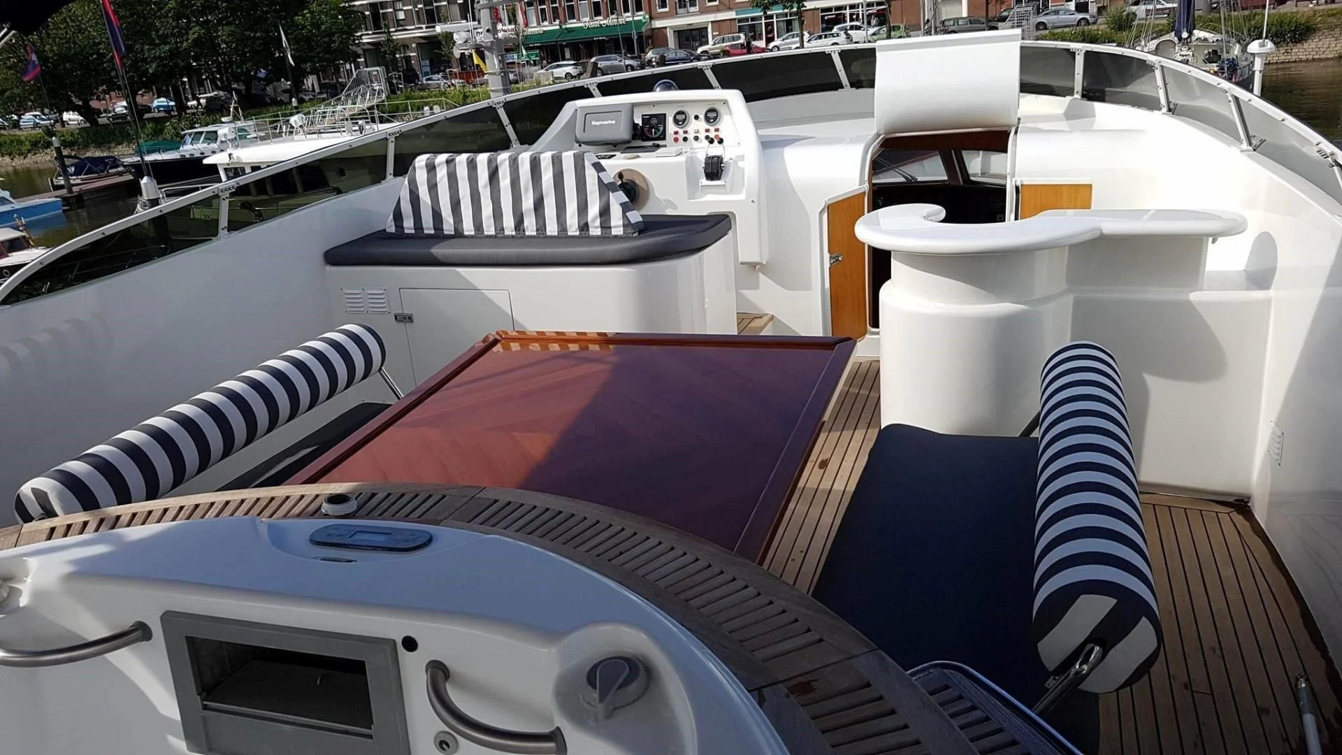 a deck with a boat and chairs aboard LADY MIKKI Yacht for Sale
