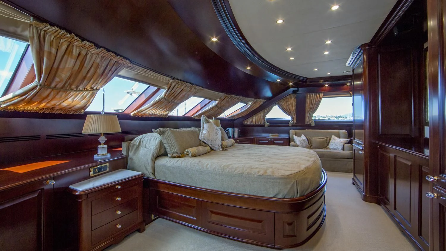 a bedroom with a bed and a desk aboard GIORGIA I Yacht for Sale