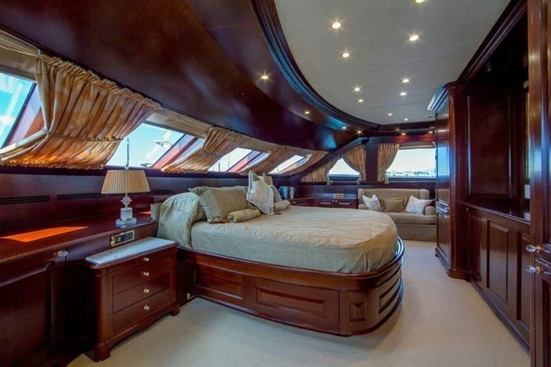 a bedroom with a bed and a desk aboard GIORGIA I Yacht for Sale