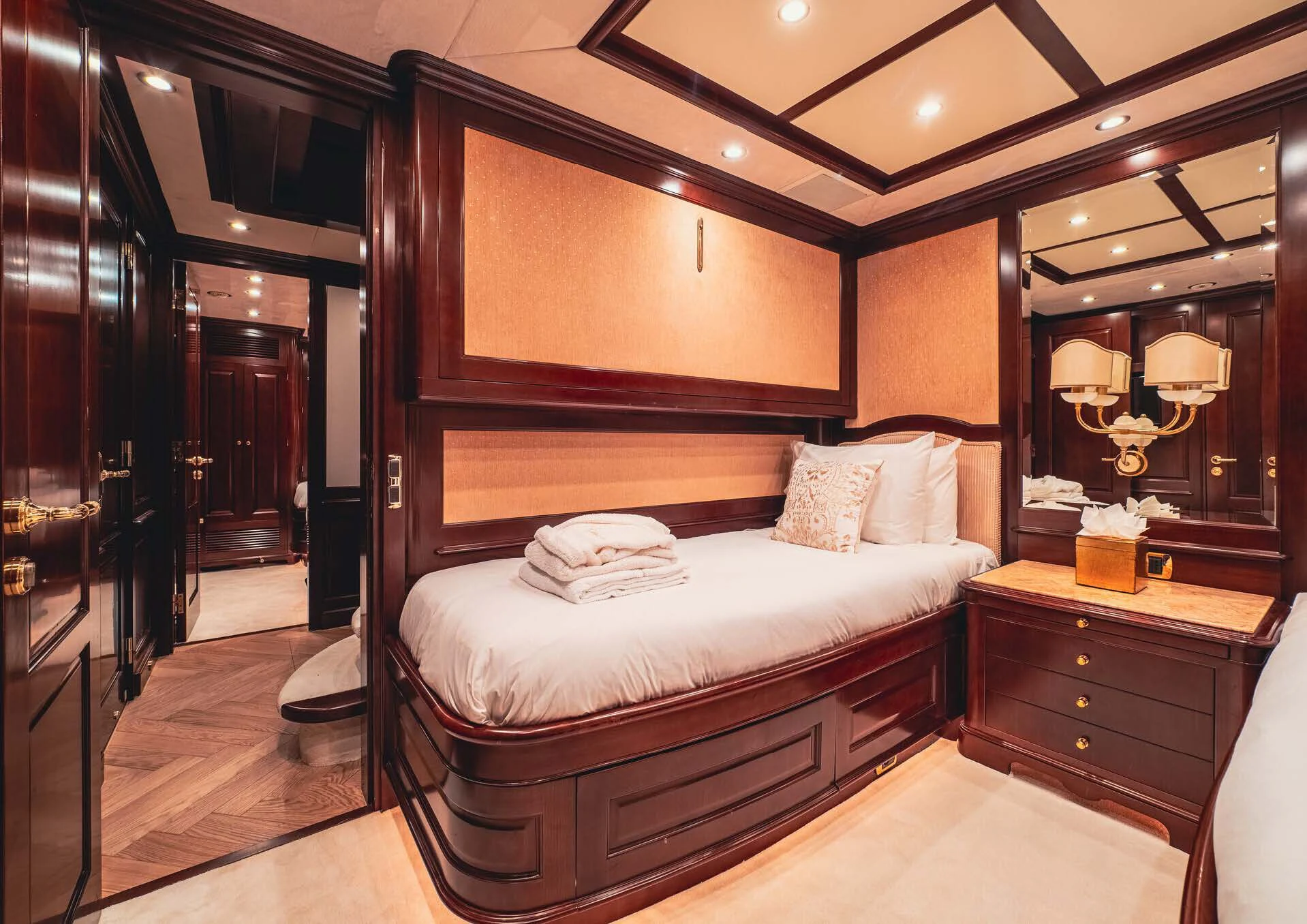 a bedroom with a bed and a mirror aboard GIORGIA I Yacht for Sale