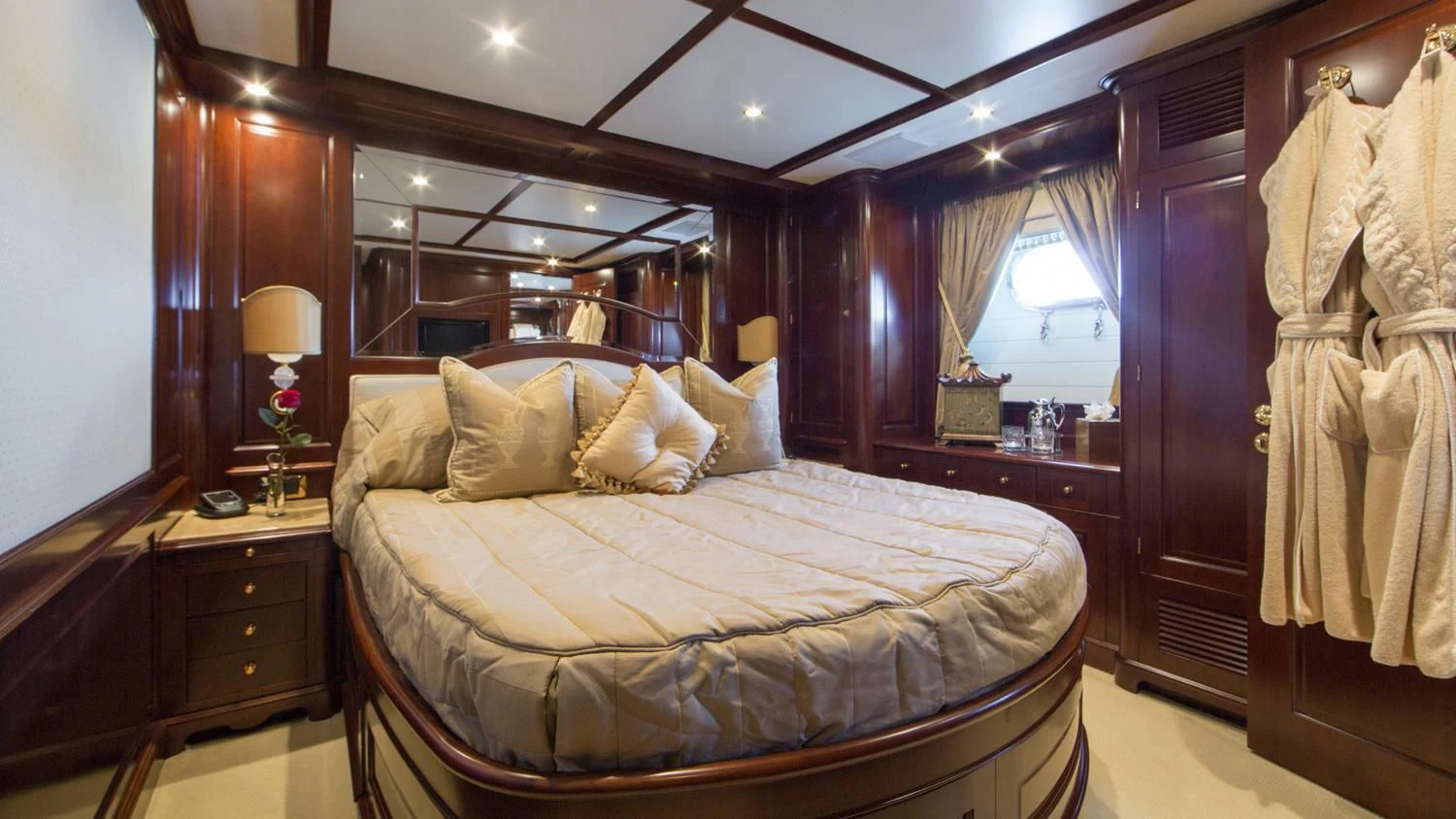 a bed with a white sheet and a wooden headboard aboard GIORGIA I Yacht for Sale