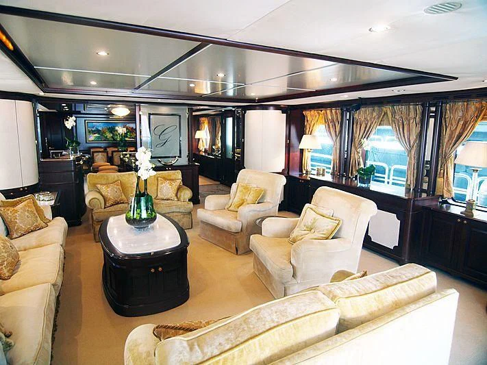 a living room with a large chandelier aboard GIORGIA I Yacht for Sale