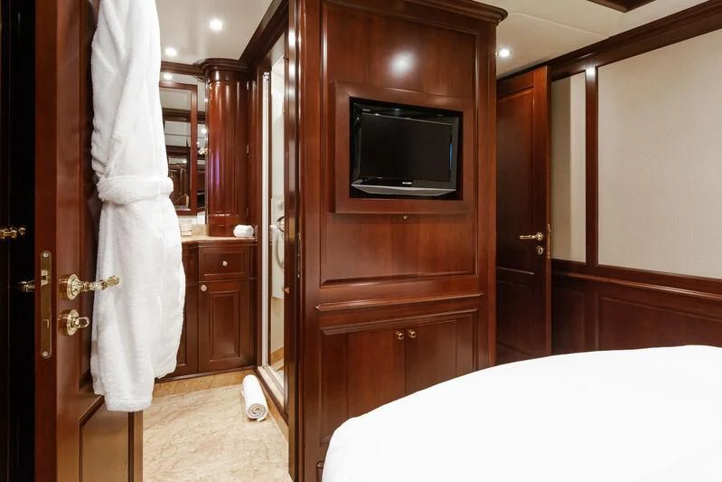 a bedroom with a bed and television aboard GIORGIA I Yacht for Sale