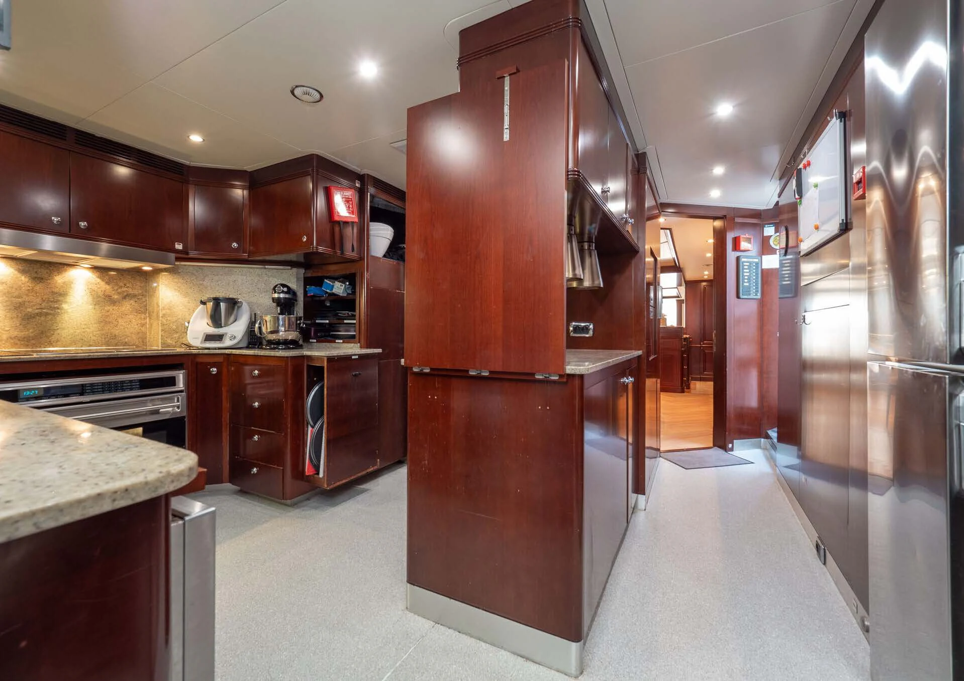 a large kitchen with wooden cabinets aboard GIORGIA I Yacht for Sale