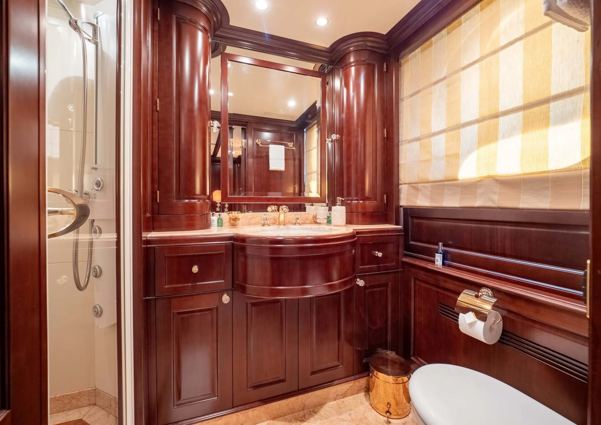 a bathroom with wooden cabinets aboard GIORGIA I Yacht for Sale