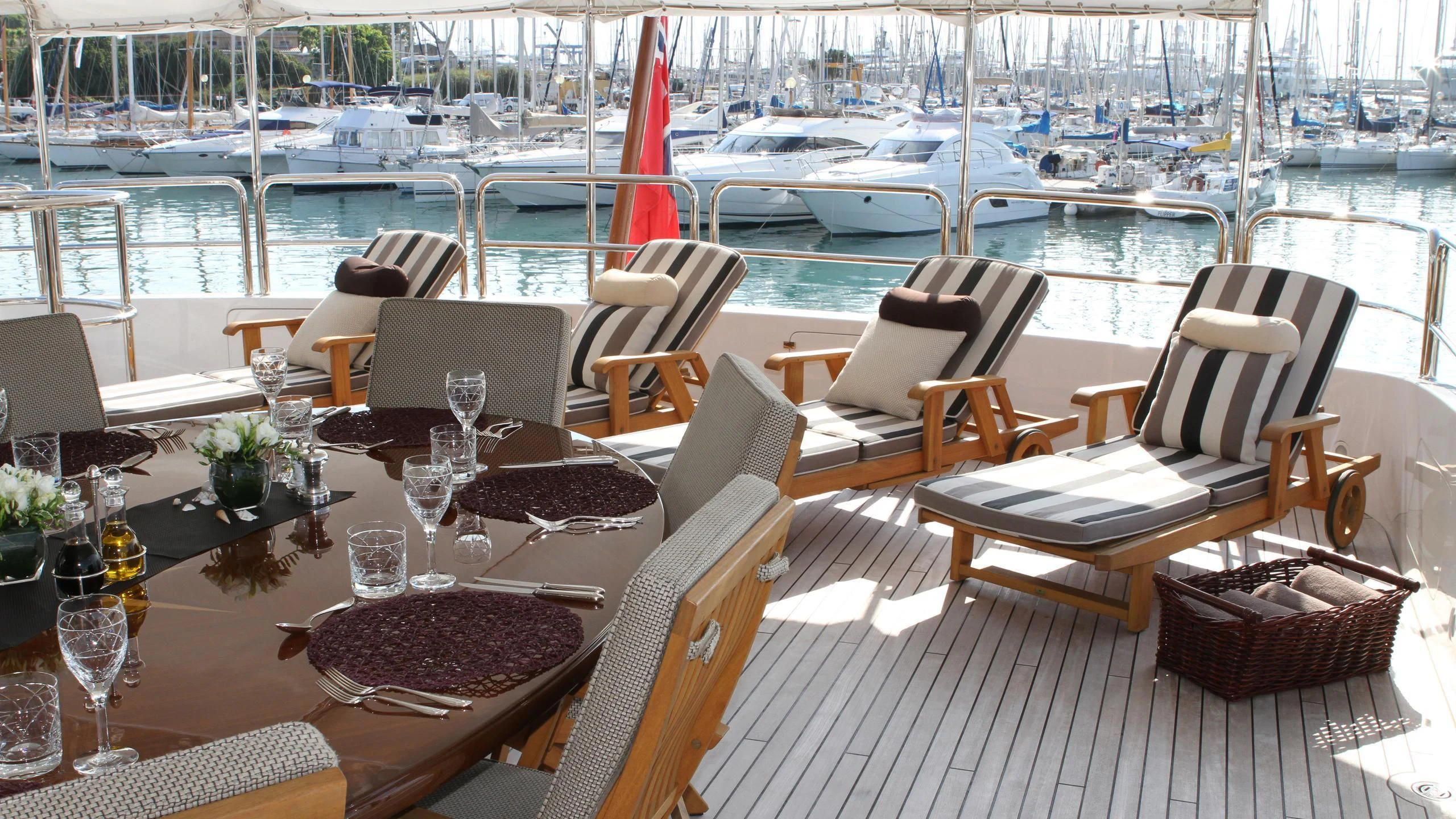 a table with chairs and a plate of food on it aboard GIORGIA I Yacht for Sale