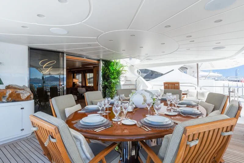a dining room with a large table and chairs aboard GIORGIA I Yacht for Sale