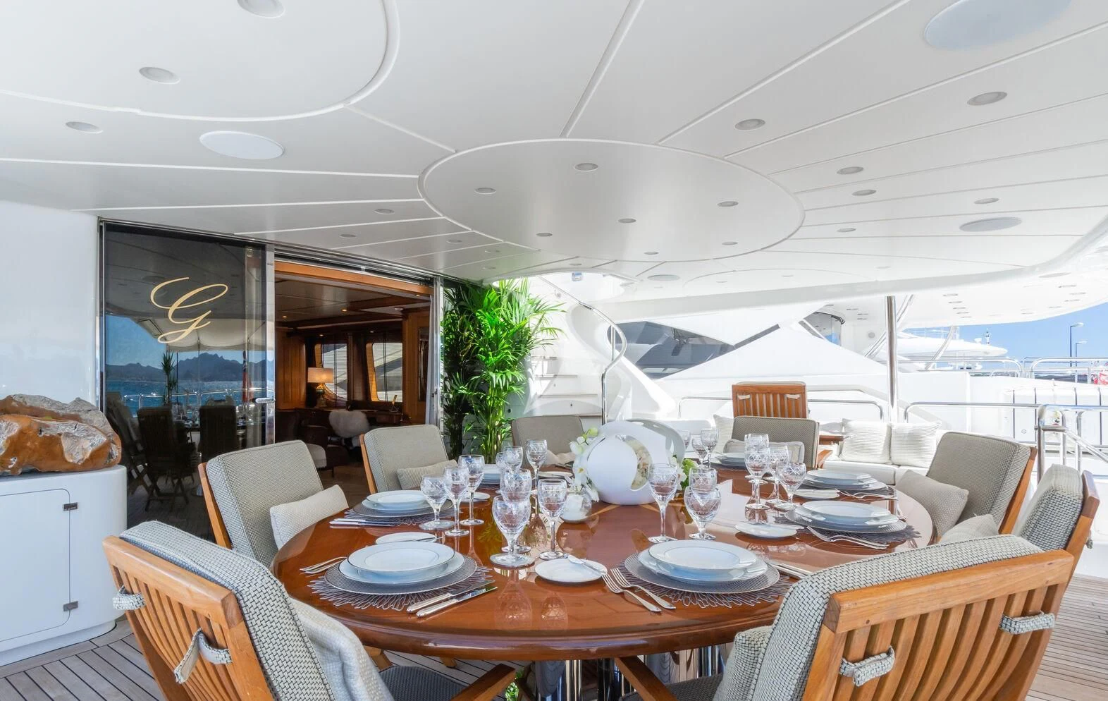 a dining room with a large white tent and a large white table with chairs and a large white aboard GIORGIA I Yacht for Sale