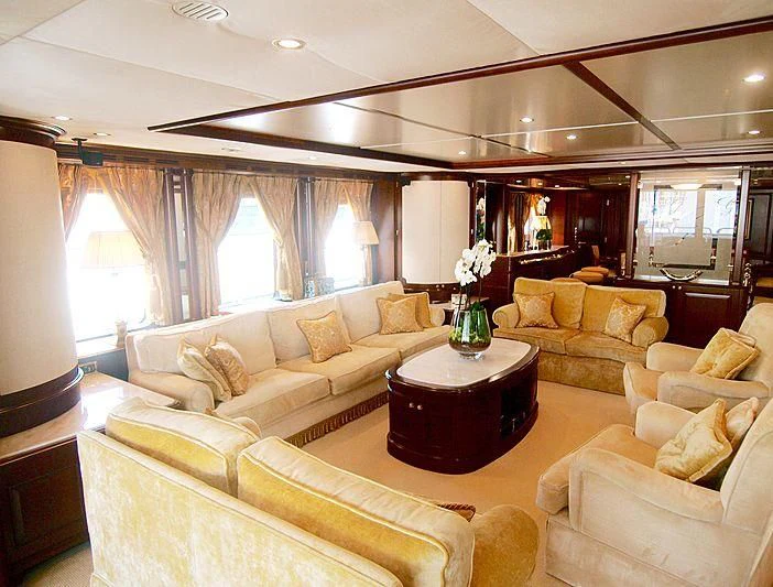a living room with a table and couches aboard GIORGIA I Yacht for Sale