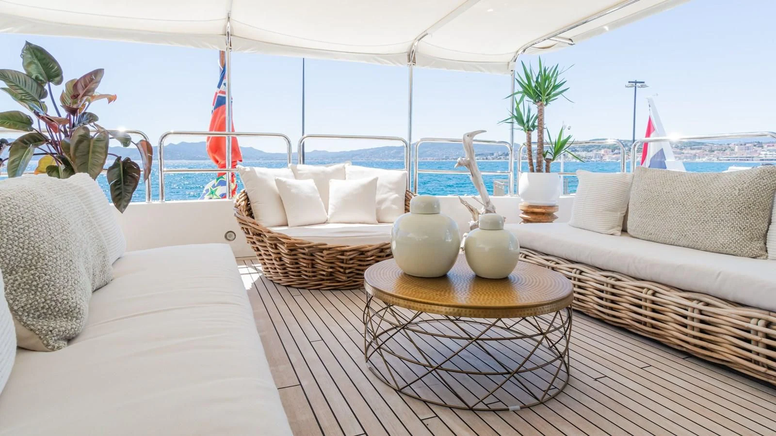 a living room with a large white tent and a table with a vase on it aboard GIORGIA I Yacht for Sale