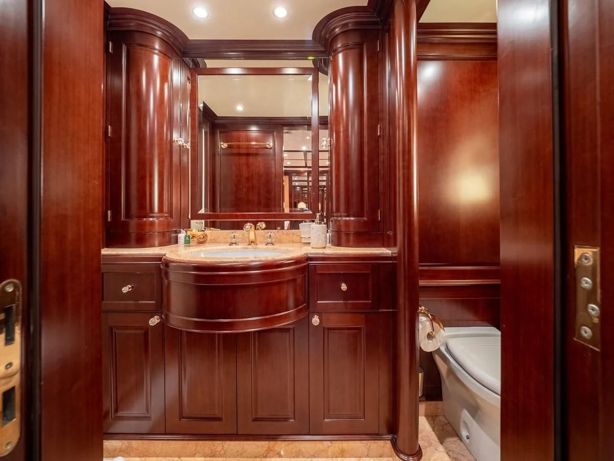 a bathroom with wooden cabinets aboard GIORGIA I Yacht for Sale