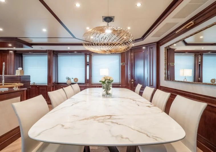 a large room with a large white table and chairs aboard GIORGIA I Yacht for Sale