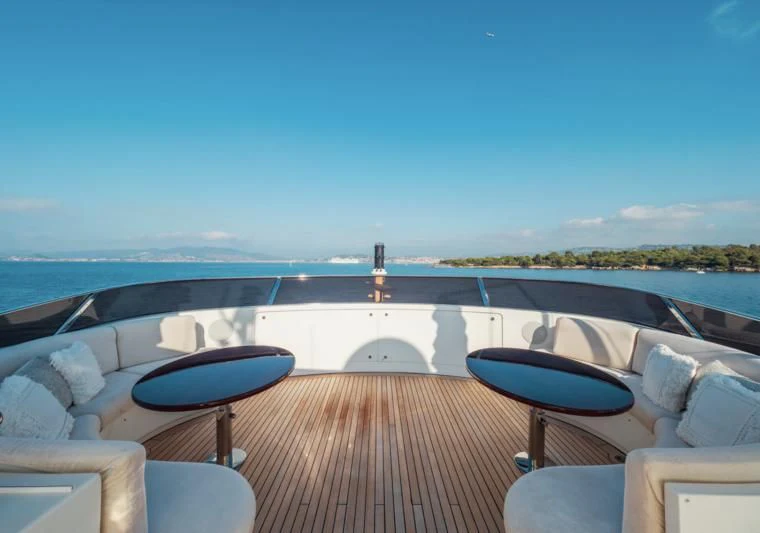 a deck with a view of the ocean and a large building aboard GIORGIA I Yacht for Sale