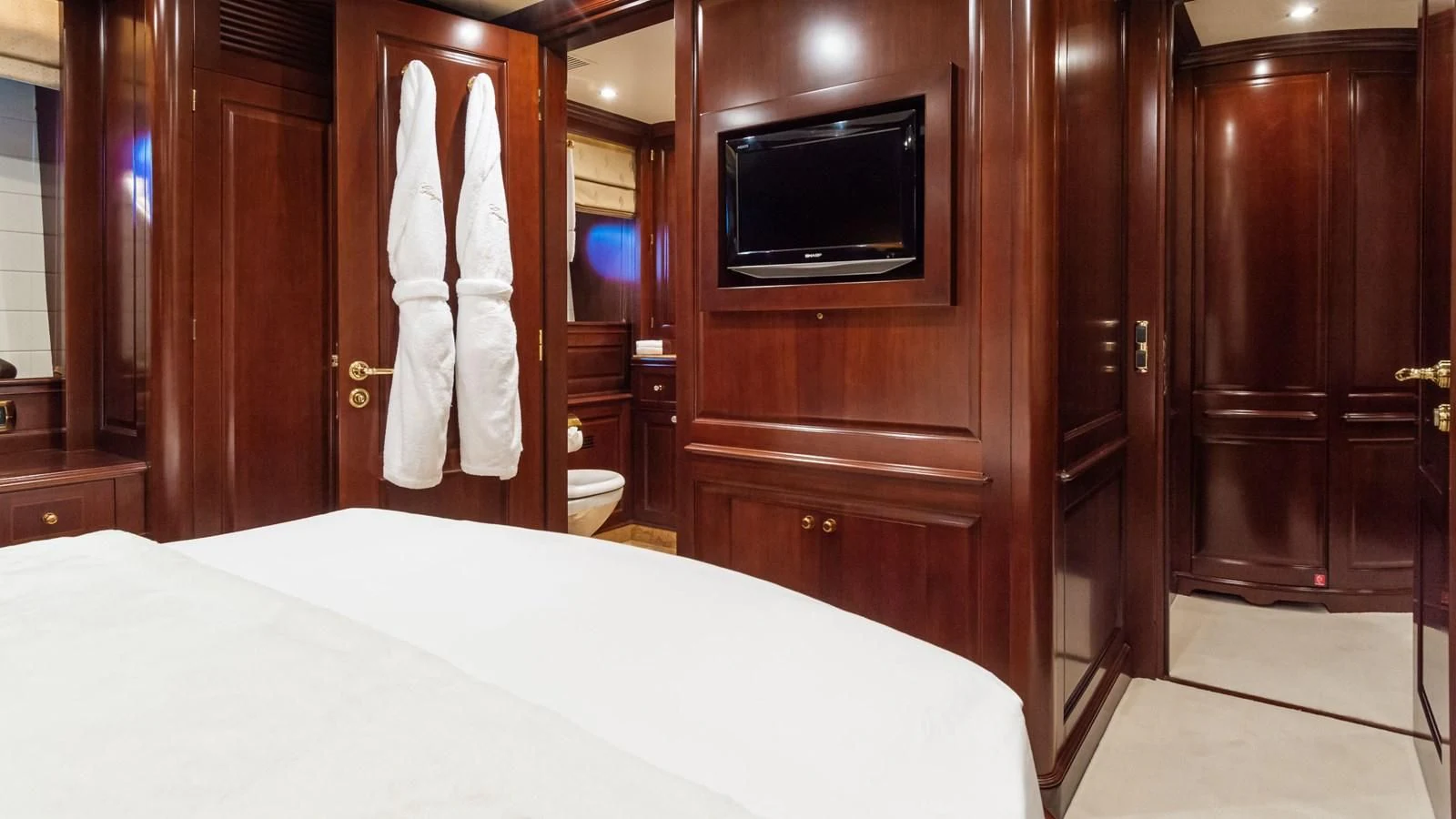 a hotel room with a tv and bed aboard GIORGIA I Yacht for Sale