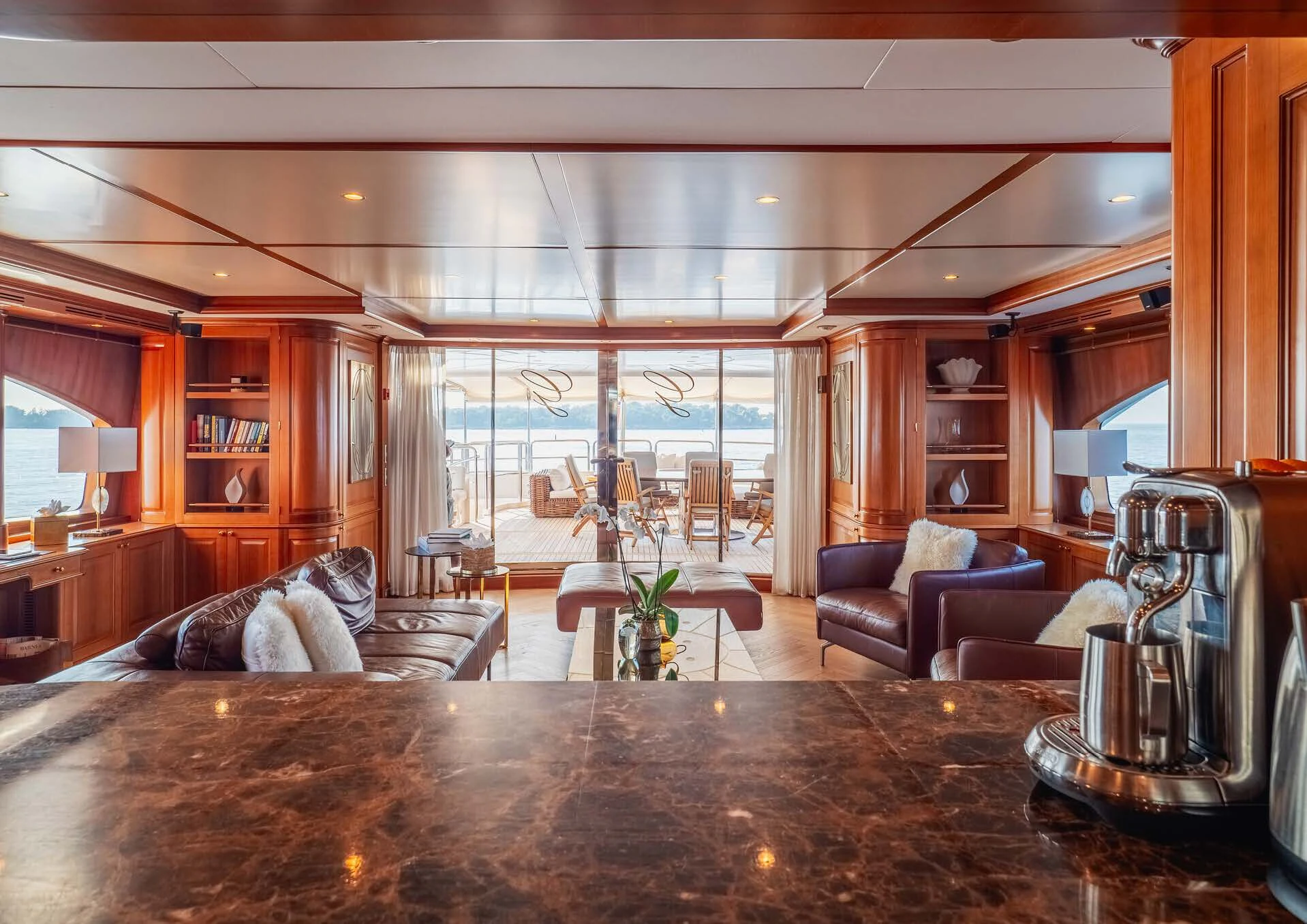 a living room with a large table aboard GIORGIA I Yacht for Sale